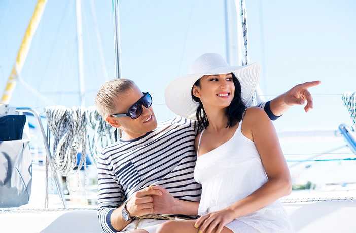 a man and a beautiful woman on a yacht